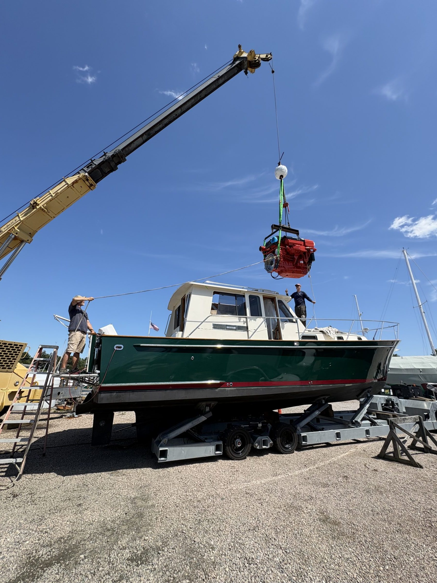 A classic sportfishing boat on stands in the yard mid-project