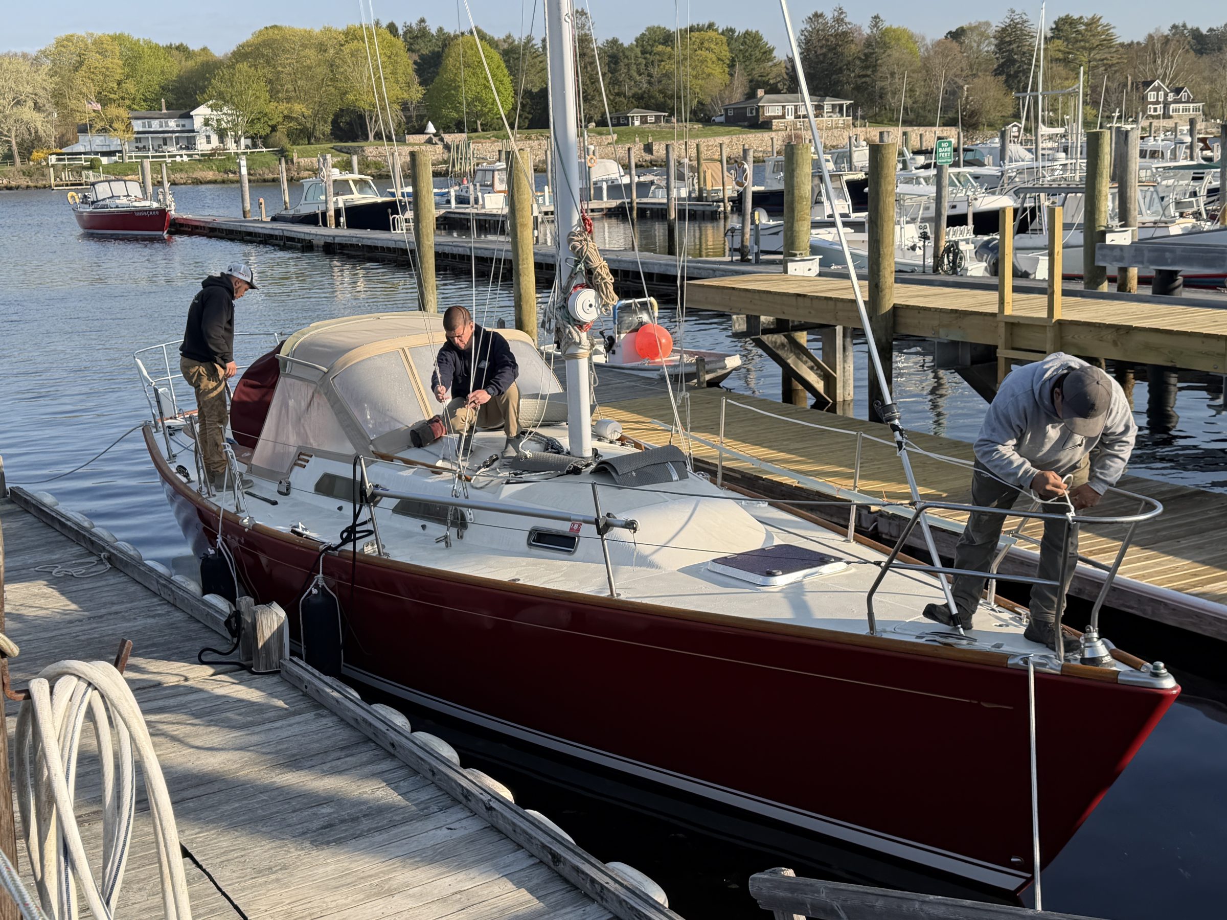 The green Frank Hall Boat Yard Travelift lifting a classic wooden yacht